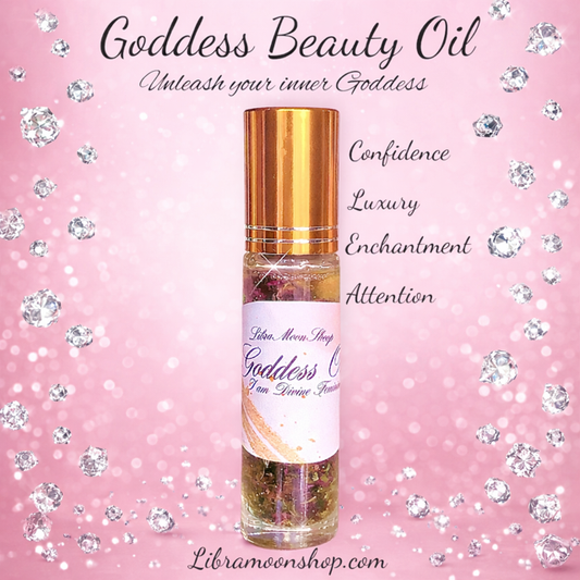 Goddess Beauty Oil bottle with gold cap on a pink background with decorative elements with the words "confidence", "luxury", "enchantment", and "attention".